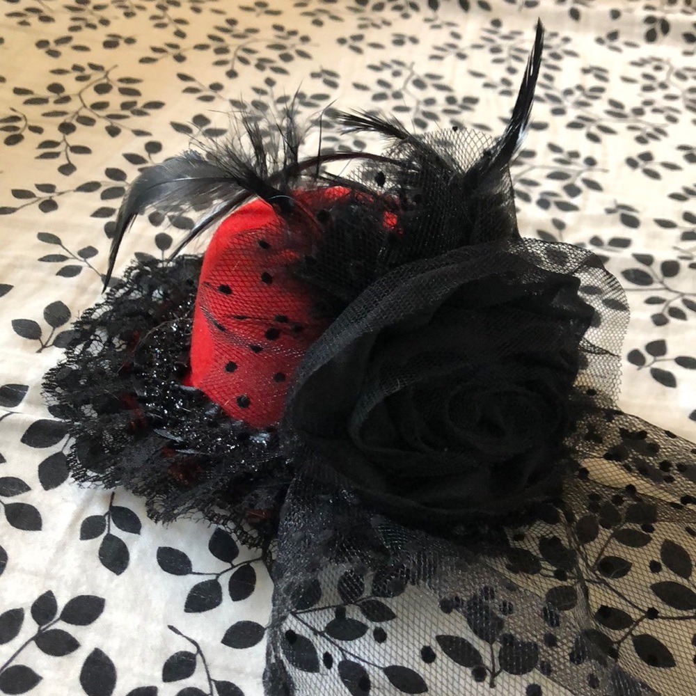 Tiny feathered hat with veil!